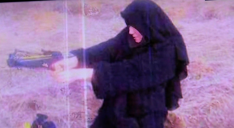 FEMALE POSING WITH GUN.