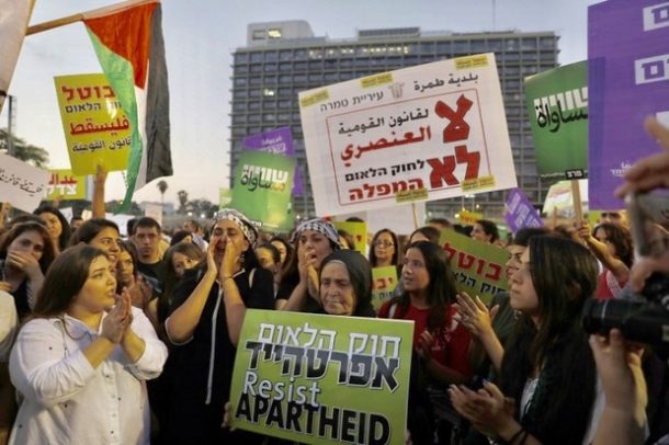 Palestinian citizens of Israel prepare to march through the centre of Tel Aviv on Saturday night (AFP)