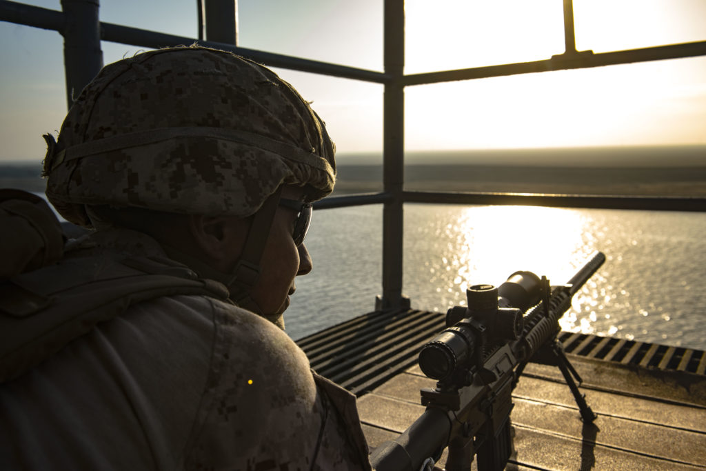 U.S. Marine stands watch on the bridge wing of the USS San Jacinto (CG 56) as the ship transits the Suez Canal. San Jacinto is deployed as part of the Eisenhower Carrier Strike Group, in the U.S. 5th Fleet area of operations.