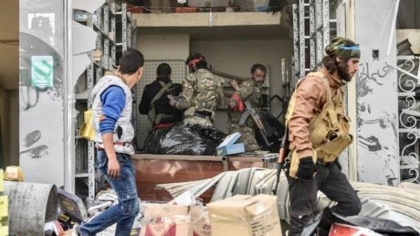 Turkish-backed militants loot shops after seizing control of Afrin on March 18, 2018. (Photo by AFP)