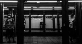 New York subway with masked riders.