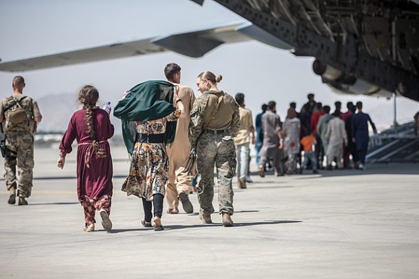A U.S. Marine escorts children to an evacuation plane at Hamid Karzai International Airport, Kabul, Afghanistan, Aug. 24, 2021.